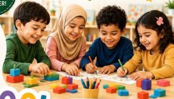 Four smiling preschoolers coloring and building with blocks together at The IEC Academy of NJ